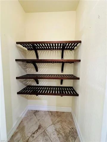 Wine room featuring light tile patterned floors