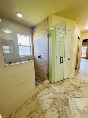 Bathroom with tile patterned flooring and a shower