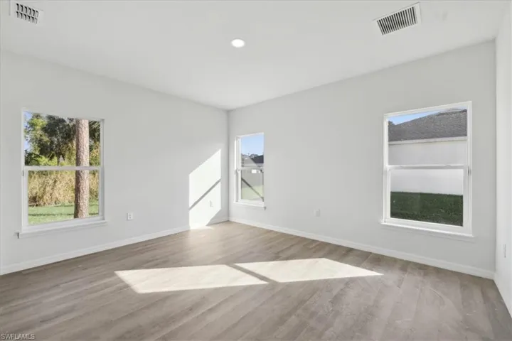 Unfurnished room with light hardwood / wood-style flooring