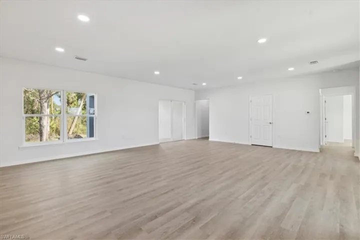 Unfurnished living room with light hardwood / wood-style floors