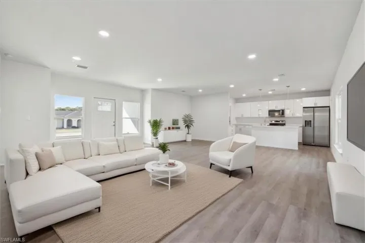 Living room with light hardwood / wood-style flooring