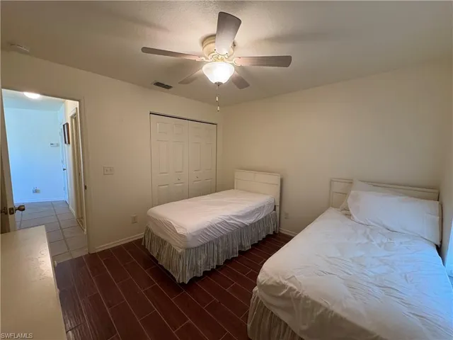 Bedroom with wood finished floors, a closet, and ceiling fan