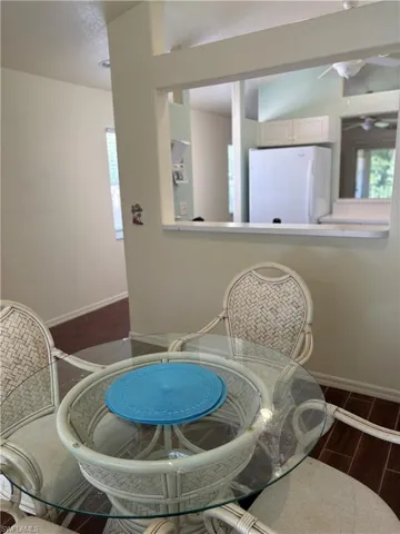 Dining area featuring wood tiled floors and baseboards