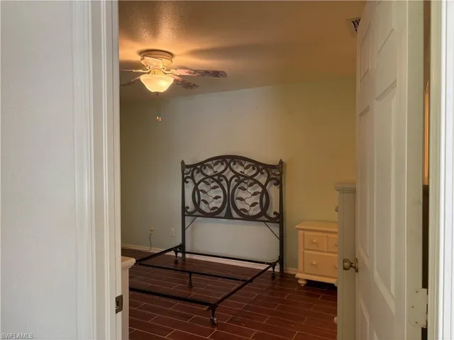 Bedroom featuring wood tiled floors and a ceiling fan