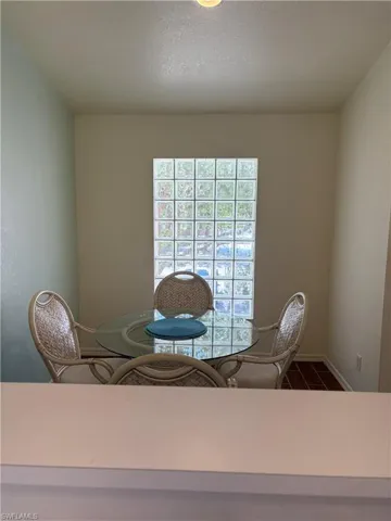 Dining room featuring baseboards and dark tile patterned floors