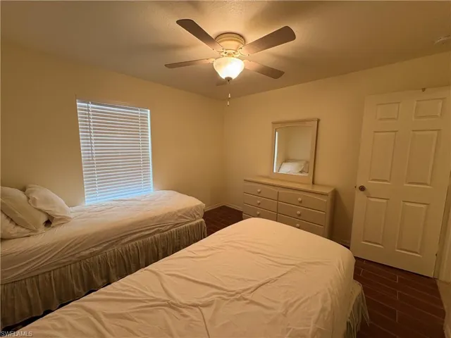 Bedroom with wood finish floors and ceiling fan