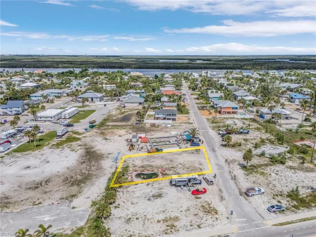 Aerial view of property's location with property parcel outlined and a large body of water