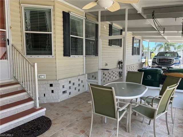 View of patio / terrace featuring a carport and ceiling fan