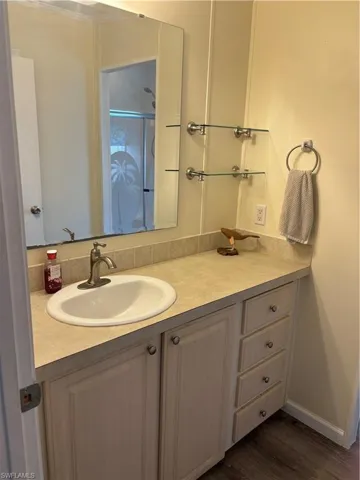Bathroom featuring vanity and hardwood / wood-style floors