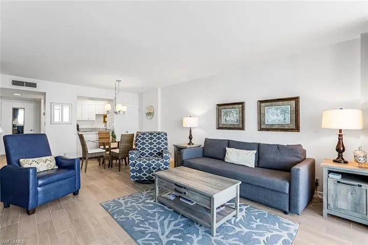 Living Room with lovely furniture and light wood look flooring.