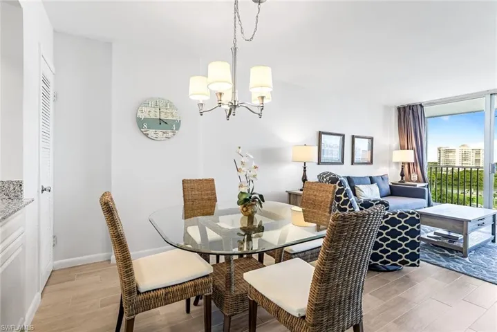 Dining area featuring a chandelier and light wood-type flooring