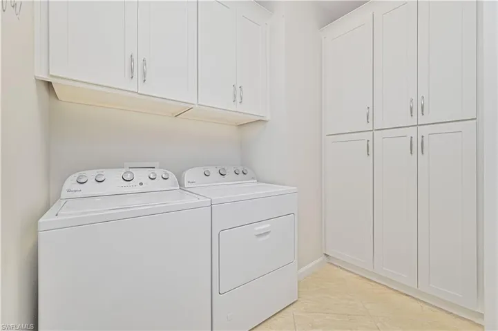 Laundry area with cabinet space and independent washer and dryer