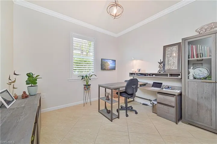 Home office with ornamental molding and light tile patterned flooring