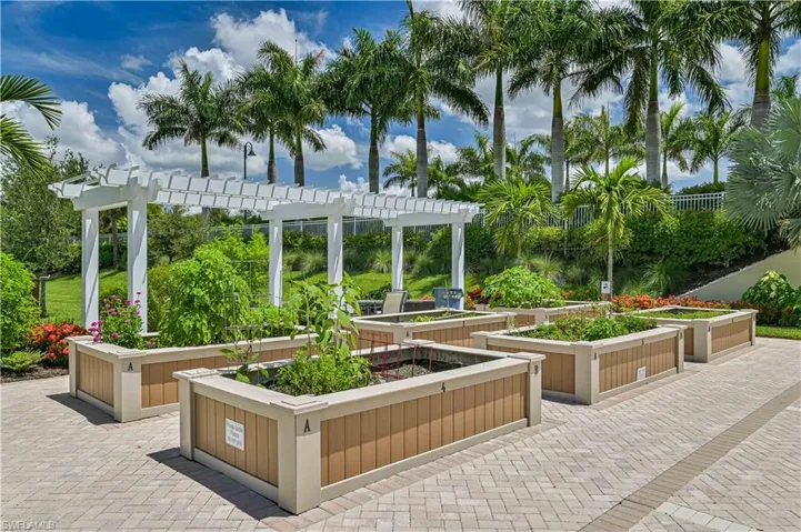 View of patio featuring a garden and a pergola