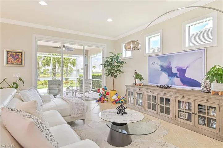 Living room with ornamental molding, ceiling fan, recessed lighting, and tile patterned flooring