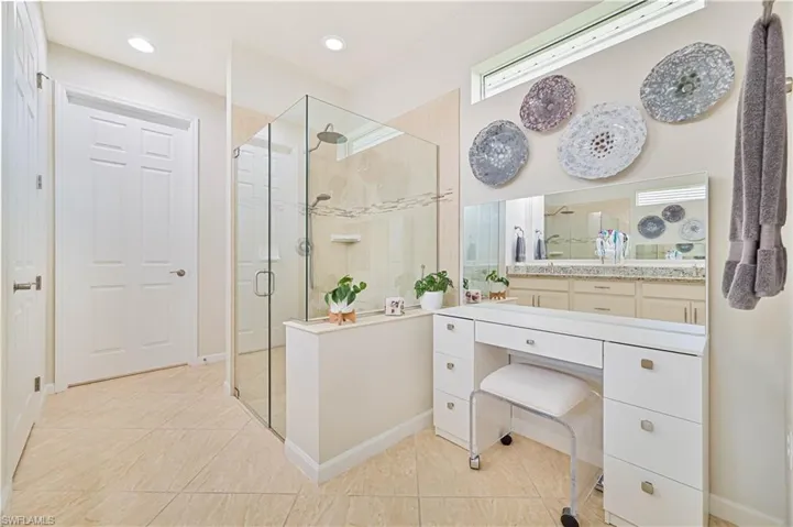Full bath with a shower stall, vanity, tile patterned floors, and recessed lighting
