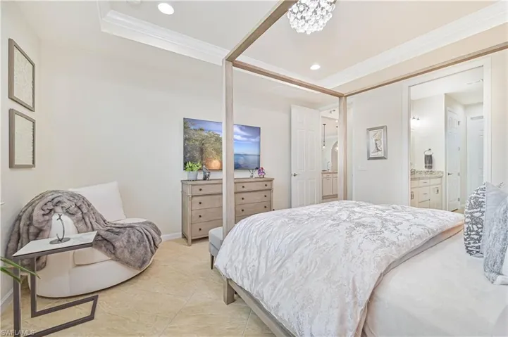 Bedroom featuring crown molding, recessed lighting, connected bathroom, and a tray ceiling