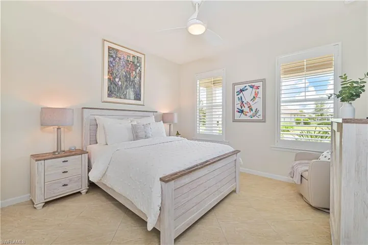 Bedroom featuring light tile patterned floors and ceiling fan