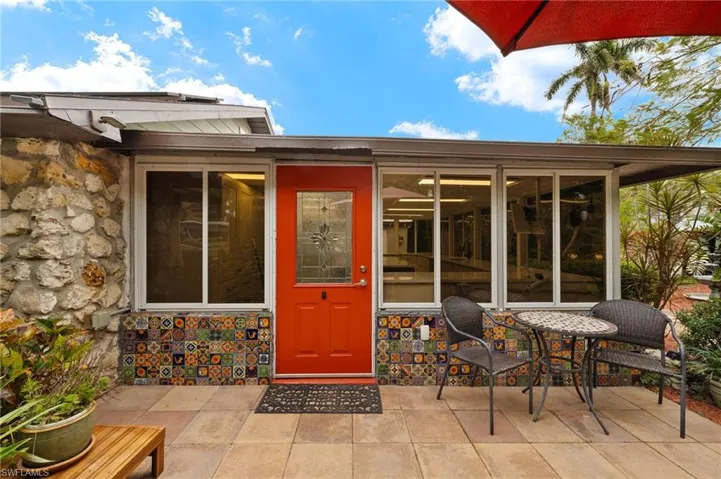 View of exterior entry with a patio area