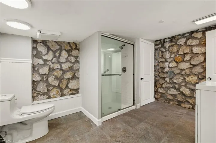 Bathroom featuring toilet and an enclosed shower