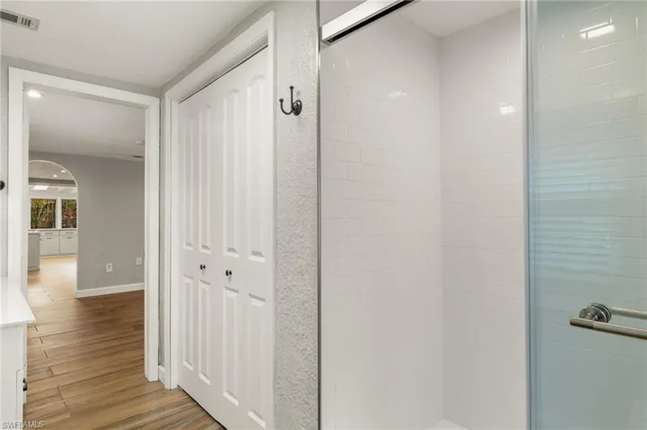 Bathroom featuring a shower with door and hardwood / wood-style flooring