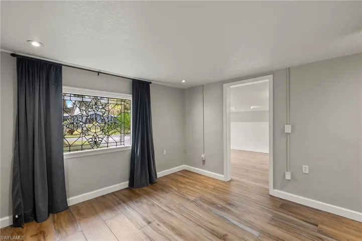 Empty room with light hardwood / wood-style floors