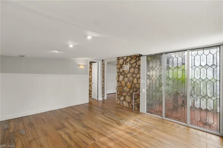 Basement with hardwood / wood-style floors