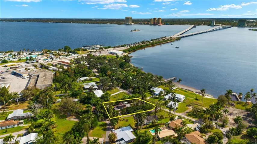 Birds eye view of property with a water view