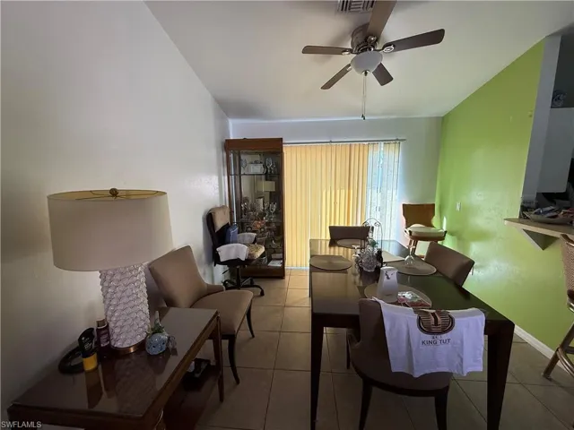 Dining area with ceiling fan and light tile patterned floors