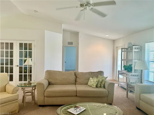 Great Room with view to Den, entrance to thrid Bedroom and Front Door.