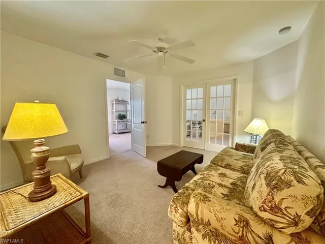 Den opening up to Great Room via French Doors and door leadin to Front Entrance area.