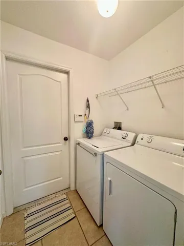 Notice alarm panel to right of door leading out to garage.