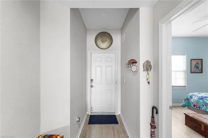 Doorway featuring vinyl finished floors and baseboards
