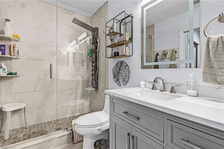 Primary bathroom featuring a stall shower and comfort height toilet