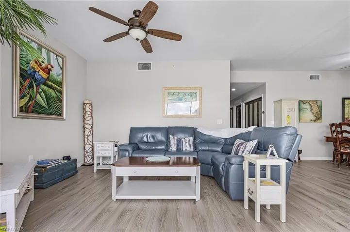 Living room featuring ceiling fan and light vinyl finished floors