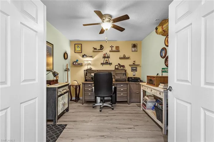 Office/den with ceiling fan and light vinyl floors