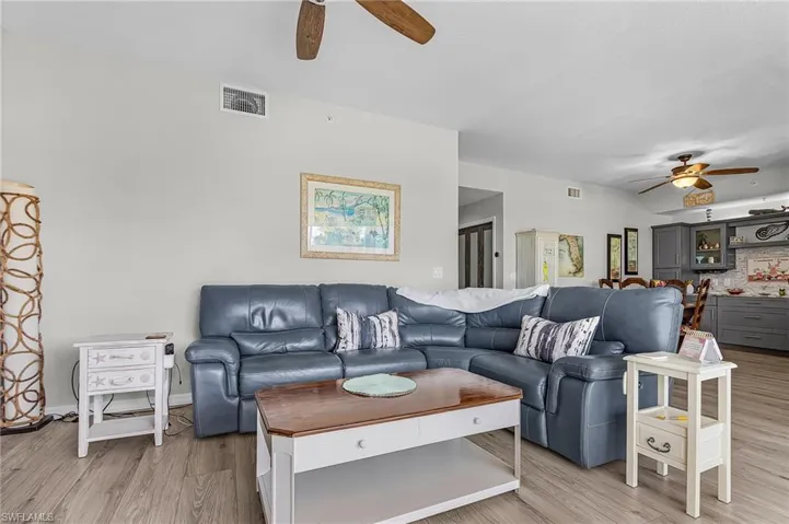 Living room with a ceiling fan and light vinyl flooring