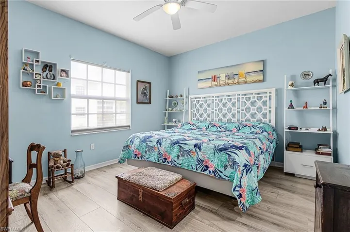 Primary bedroom featuring vinyl flooring and a ceiling fan