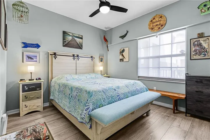 Bedroom with vinyl finished floors and a ceiling fan
