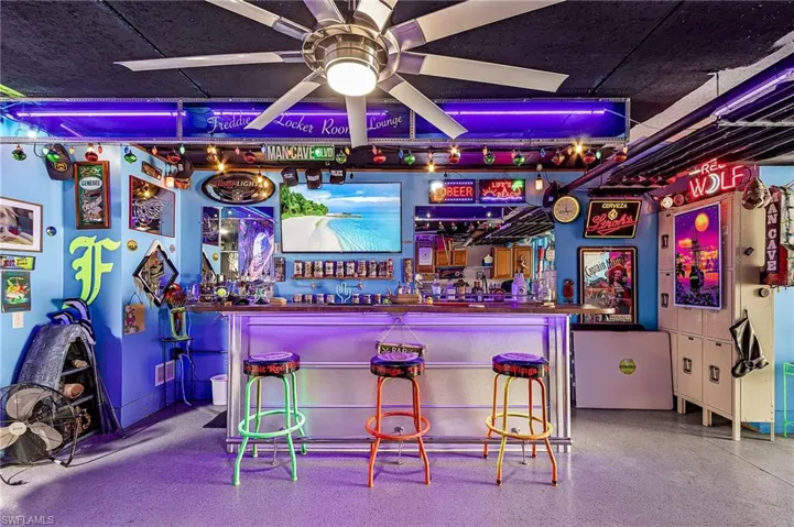 Garage featuring bar area with ceiling fan