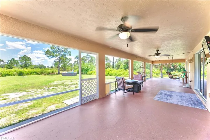 Unfurnished sunroom featuring ceiling fan