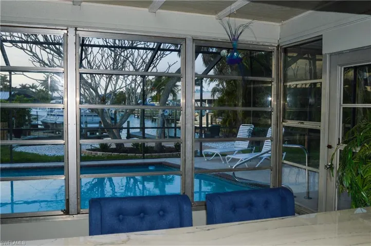 Breakfast bar with view of pool and waterfront canal