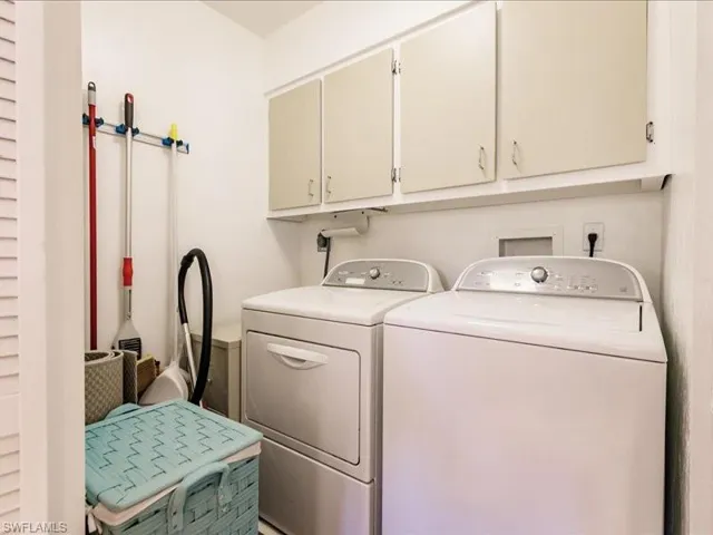 Clothes washing area with washing machine and dryer and cabinets