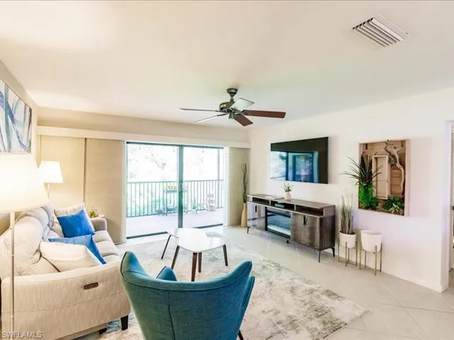 Tiled living room featuring ceiling fan