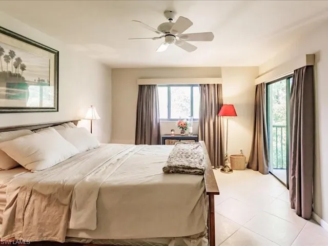 Bedroom featuring ceiling fan, multiple windows, access to outside, and light tile floors