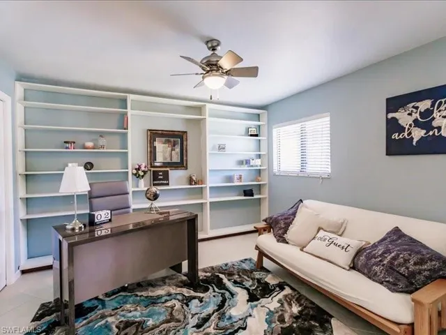 Tiled home office featuring ceiling fan