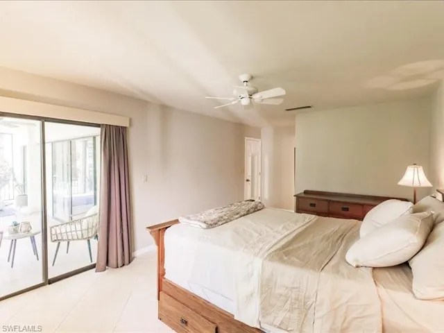 Bedroom featuring access to outside, ceiling fan, and light tile floors