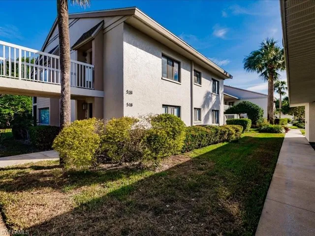 View of side of home featuring a balcony