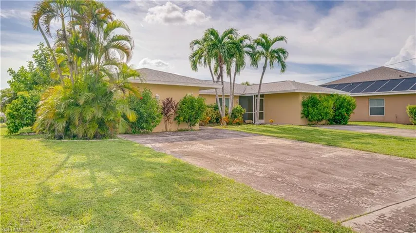 View of front of Duplex featuring a front yard