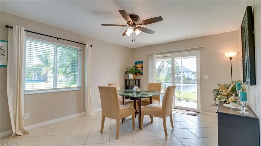Dining area featuring light tile patterned flooring and ceiling fan
